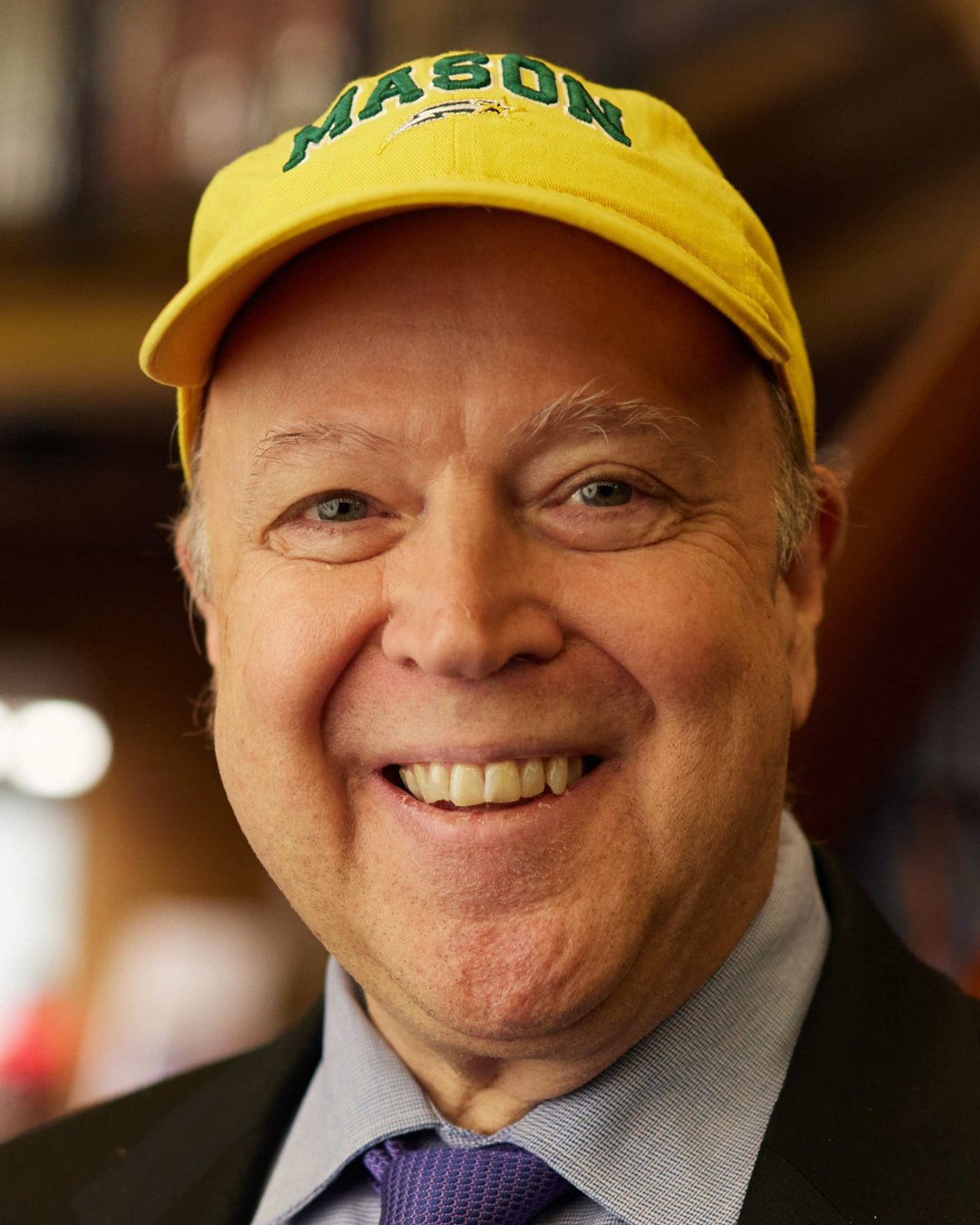 Rick Davis Headshot, wearing yellow mason hat and suit
