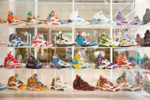 a colorful collection of Air Jordan 5s made of recycled materials in a clear case