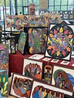 Artist Jose Quinonez poses with his artwork.